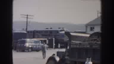 Nebraska USA (1959): One Person Walking In The Road And Another Person Taking A