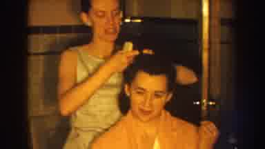 Nebraska USA (1959): Woman Does Other Woman's Hair In Mid Century Home While Man