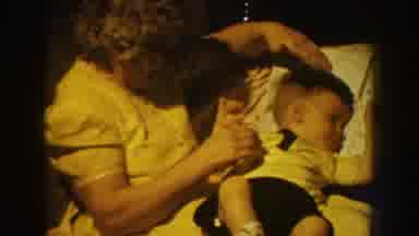 Nebraska USA (1959): Grandma Calming Down Grandchild While Visiting During The