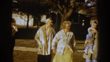 Nebraska USA (1959): Family Gatherer In Front Of Camera With Two Kids While A Man