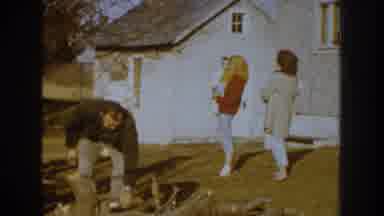 Nebraska USA (1959): Two Guys Loading Wood Into The Back Of A Family Vehicle