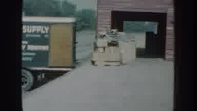 Nebraska USA (1959): View Of Cars In Parking Lot And Items Sitting On Loading Dock