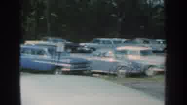 Nebraska USA (1959): Showing Different Cars In A Parking Area Near A Truck