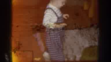 Nebraska USA (1959): A Child Walking Across A Room And Then Two Older Cars Sitting
