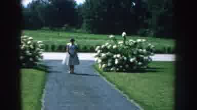Nebraska USA (1959): Woman Poses For Photo In Beautiful Flower Garden On Beautiful