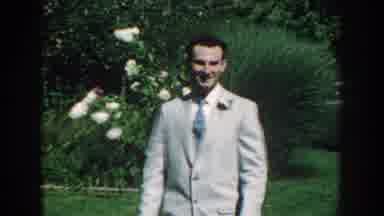 Nebraska USA (1959): A Man Wearing A Suit Walking Across The Backyard Of Trees