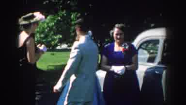 Nebraska USA (1959): Woman In Blue Dress Seen Outdoors Beside Conversing Adults