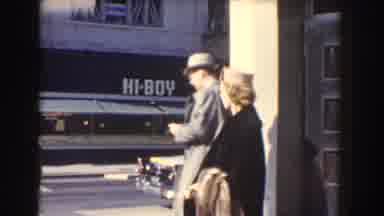 Washington DC USA (1960): A Woman Is Waiting For A Cab While A Young Man Is