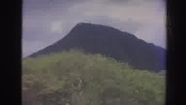 Hawaii USA (1961): Mountains Sea Rocks And Weaves In The Ocean In Clear Blue Sky