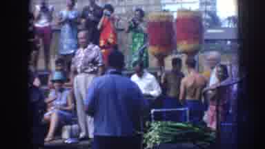 Hawaii USA (1961): People At A Gathering, Man Putting Liquid To Make A Fire