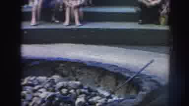 Hawaii USA (1961): Men Wearing Colorful Wraps Raking Coals In Deep Fire Pit