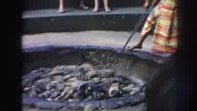 Hawaii USA (1961): A Hot Coal Is Picked Up And Placed On An Animal Carcass