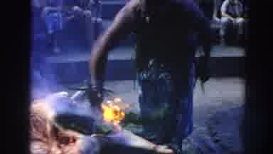 Hawaii USA (1961): Man Cooking Meat Using Traditional Methods