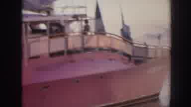 Hawaii USA (1961): A Boat In Harbor And A Person Surfing Calm Waves In The