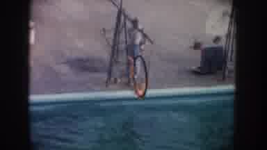 California USA (1962): Dolphin Jumps Out Of Water Through Flaming Hoop For A Show