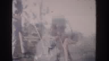 Anaheim California USA (1962): Woman Putting Child Into Stroller While Another