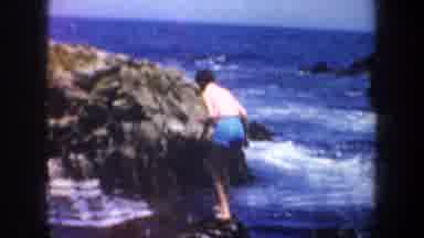 San Francisco California USA (1957): A Man Standing On Rocks In The Sea As The