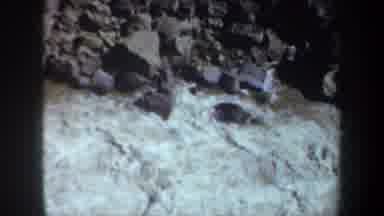 PORTLAND OREGON USA-1957: River Flowing Over Rocks with Boy Sleeping on Grass