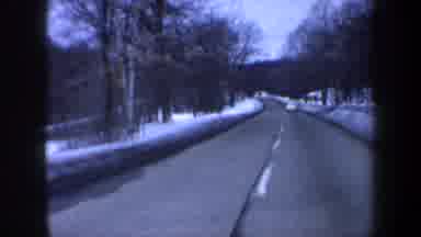New Hampshire USA-1962: Car Driving On Snowy Road In Winter Landscape