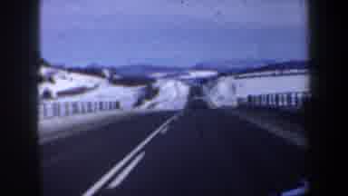 New Hampshire USA (1962): Driving On A Two-Lane Highway Through Snow Behind