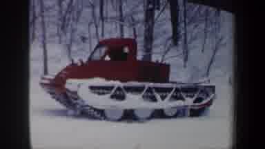 New Hampshire USA (1962): Red Snow Plow Moving Through Trees On A Winter Day