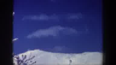 New Hampshire USA (1962): People Skiing On A Snow Covered Hill Under A Blue Sky