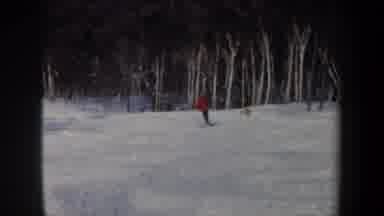 New Hampshire USA (1962): A Couple Of Winter Dressed Skiers Chase Each Other On A