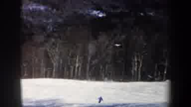 New Hampshire USA (1962): Person In Blue Jacket Skiing Down White Hills Beside A