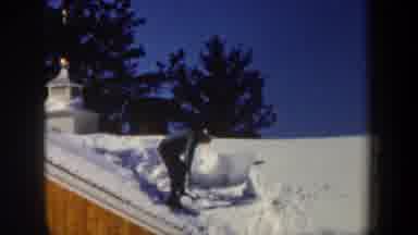 New Hampshire USA (1962): Man Shoveling Snow From The Roof Of The House With A Lot