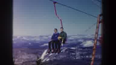 New Hampshire USA (1962): Two People Going Up A Ski Lift To The Top Of A Mountain