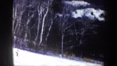 New Hampshire USA (1962): Two People Skiing Downhill On A Bright Sunny Winter Day