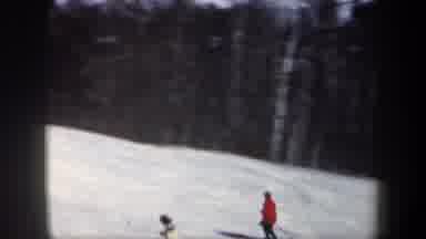 New Hampshire USA (1962): A Man Skiing Down Hill On White Snow During A Winter Day