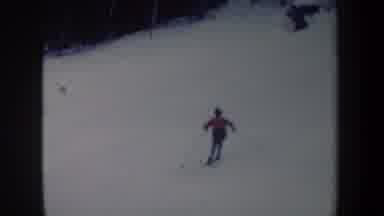 New York USA (1962): Person Wearing Red Jacket Skiing Downhill On A Sunny Winter