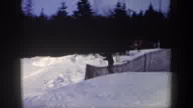New York USA (1962): A Skier Goes Rocketing Down The Hill Past A Fence