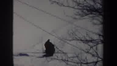 New York USA (1962): Man Rides Dog Sled Through Snowy Mountainous Area Filmed By