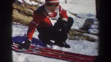 New York USA (1962): Kids Prepare Their Skis Among The Snowy Landscape On A Clear