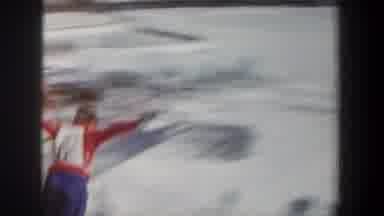 New York USA (1962): A Skier Jumps A Snow Jump In Front Of A Crowd On A Cold Day