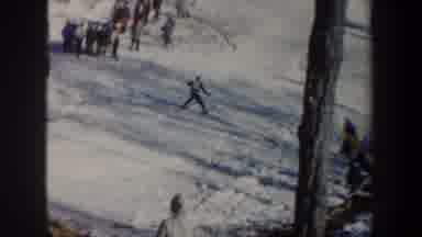 New York USA (1962): Man Ski Jumping Then Sliding Quickly Downhill While People