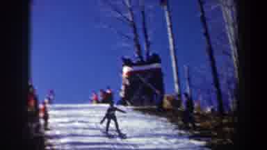 New York USA (1962): Skier Jumping In Competition Finishing A Maneuver With The