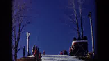 New York USA (1962): A Skier Going Down A Slope Lined With People And Then Falling