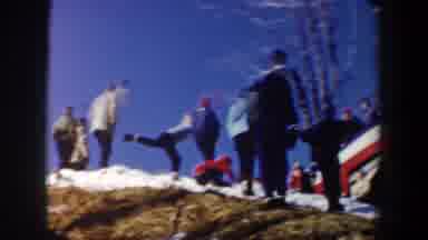 New York USA (1962): Group Of People Watching Skier Doing A Jump Down The Slope