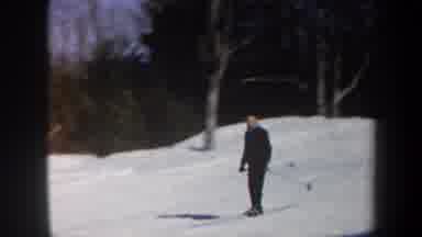 Vermont USA (1962): Man Wearing Black Skiing Downhill On A Bright Sunny Day