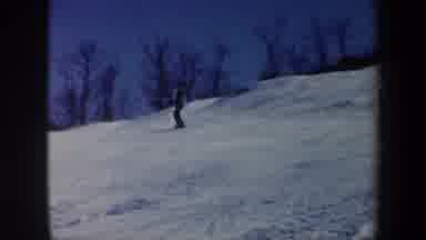 Vermont USA (1962): A Man Skiing Down Hill On Snow During A Winter Day With Some