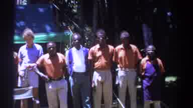KENYA-1969: Group of Men Standing Outdoors in a Wooded Area