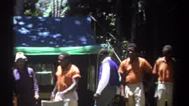 Kenya (1969): Group Gathering At Blue Tent Party Grounds Outside Sunny Day In