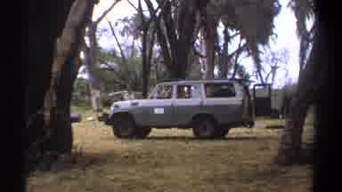 Kenya (1969): Gray Vehicle With White Sign On DriverâS Door Is Parked With Back