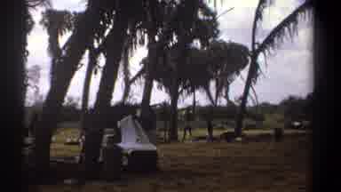 Kenya (1969): Person Folding White Cloth Outdoors Transitions Showing Parked Black