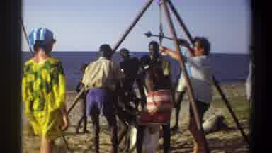 Nigeria (1969): Group Of People Hanging Huge Fish From A Scaffold Near The Sea