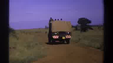 Lagos Nigeria (1969): A Canvas Covered Truck Drives Down A Dirt Roadway With