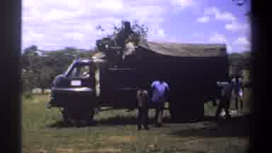 Lagos Nigeria (1969): A Truck Being Unloaded By Five People On A Sunny Day